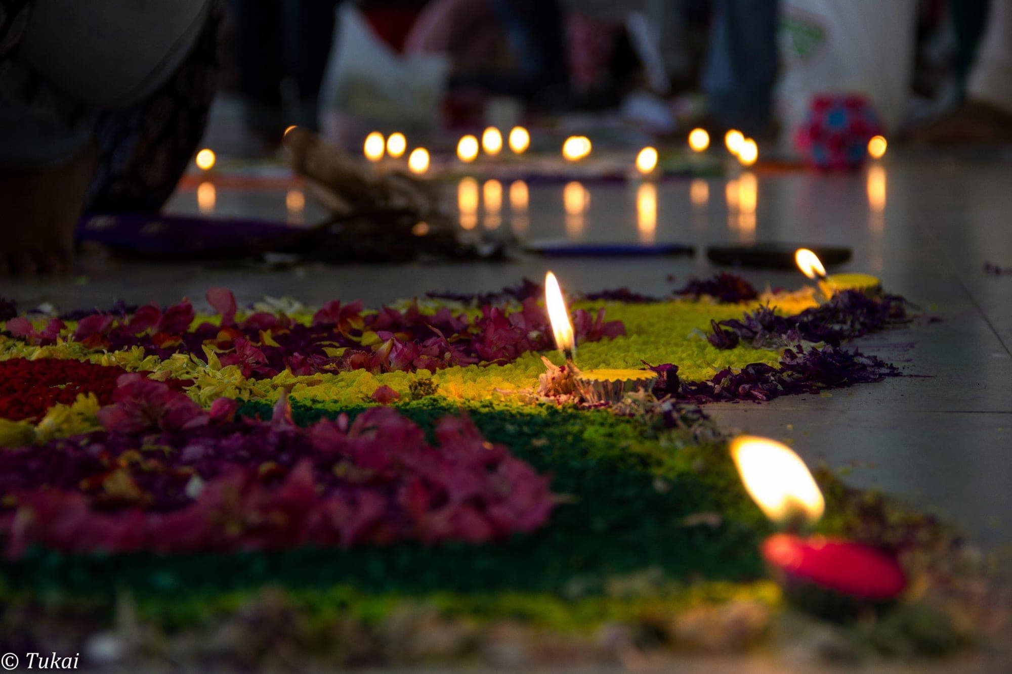 Hands cradling a lit Diwali diya